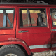 Old red Jeep Cherokee loaded with beekeeping equipment and supplies.