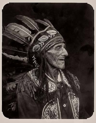 unnamed (13) Ancient Native American woman wearing traditional feathered headdress and attire.
