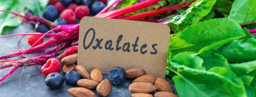 Organic blueberries, almonds, beetroot greens, and raspberries with "OxaLatcs" tag on Natural Stone surface.